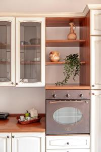 a kitchen with white cabinets and a stove at La casa di Chiara in Livorno