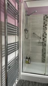 a bathroom with a shower with a glass door at Idyllic Countryside Retreat in Durham County near Sedgefield in Trimdon Grange