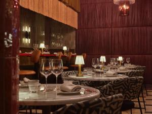 a row of tables in a restaurant with wine glasses at Hotel Morris Sydney, Handwritten Collection in Sydney