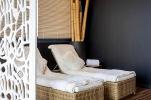 a living room with two chairs and a wall at Best Western Plus Thionville Centre in Thionville