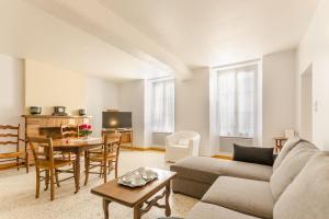 uma sala de estar com um sofá e uma mesa em Le gite de l'orvin em Courgenay
