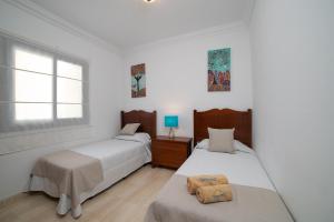 a bedroom with two beds and a window at Mireya Apartment in Playa Blanca