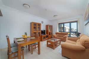 a living room with a table and a couch at Mireya Apartment in Playa Blanca