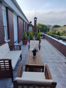 a patio with benches and tables on a building at C03A02 Apartamento con piscina y garaje in Cicero