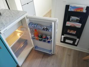 a small refrigerator with its door open in a kitchen at Centrum Aarhus in Aarhus