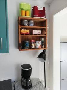 a kitchen with a black stool and a shelf at Centrum Aarhus in Aarhus