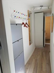 a room with white drawers and a mirror at Centrum Aarhus in Aarhus