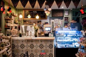 a restaurant with a counter with a food counter at Pangsuree Art Home in Lampang