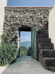 an entrance to a stone building with a green door at Reza house in Branik