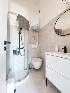 a bathroom with a shower and a toilet and a sink at Apartment Casa Di Nono in Baška