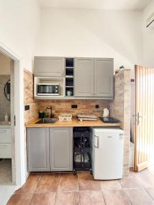 a kitchen with stainless steel cabinets and a sink at Apartment Casa Di Nono in Baška