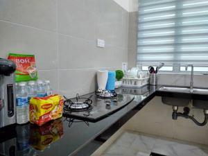 a kitchen with a sink and a counter top at HOMESTAY BATU PAHATKU- HOMESTAY IMAN in Batu Pahat