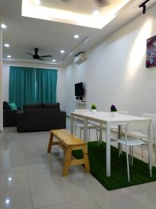a living room with a white table and a couch at HOMESTAY BATU PAHATKU- HOMESTAY IMAN in Batu Pahat