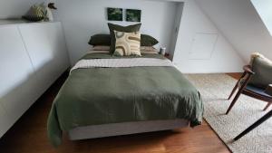a bedroom with a bed with a green comforter at Paddington House in Sydney +53 photos