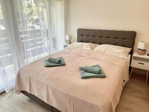 a bedroom with a bed with two towels on it at Bella Luna in Balatonfüred
