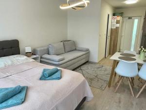 a living room with a bed and a couch at Bella Luna in Balatonfüred