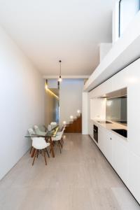 a kitchen and dining room with a table and chairs at Paddington House in Sydney