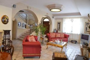 a living room with two red couches and a table at Victoria House in Mascalucia
