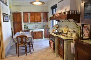 a kitchen with a table and a dining room at Victoria House in Mascalucia