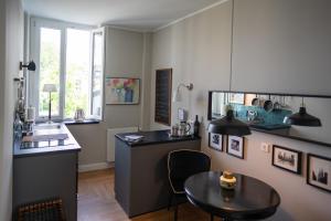 a kitchen with a table and a sink at Pssst ! Geheimtip in Rüttenscheid in Essen