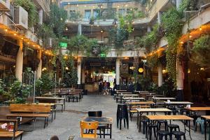 an empty restaurant with tables and chairs in a building at Romano Neve Tzedek Penthouse in Tel Aviv