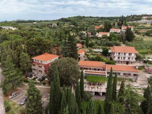 an aerial view of a town with trees and buildings at Hotel Laguna Deluxe - Terme Krka in Strunjan