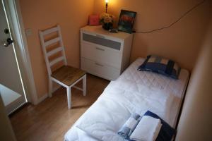 a bedroom with a bed and a chair and a dresser at Bastu hus 3km sandstrand klubbhus och disco in Värnamo