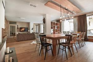 ザコパネにあるMonte House Apartments Odkryj Zakopaneのダイニングルーム、リビングルーム(木製テーブル、椅子付)