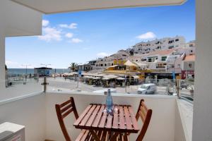 a table and chairs on a balcony with a view of a city at Hotel Carvoeiro Plaza in Carvoeiro