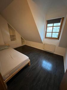 an attic room with a bed and a window at Monteurzimmer Linz in Linz