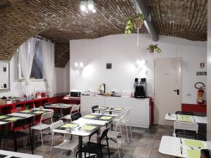 a restaurant with tables and chairs and a kitchen at Hotel Seiler in Rome