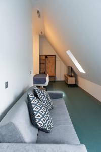 a loft room with a couch and two pillows at RK Farallón Canteras in Las Palmas de Gran Canaria