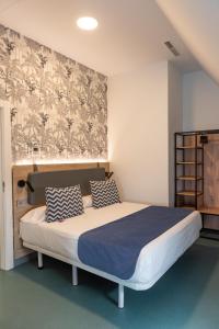 a bedroom with a large bed with a wall mural at RK Farallón Canteras in Las Palmas de Gran Canaria
