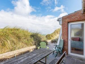 Lild Strandにある10 person holiday home in Fr strupのパティオ(木製ベンチ、椅子2脚付)