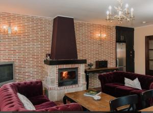 a living room with a brick wall with a fireplace at Entrada Río Lobos in Hontoria del Pinar