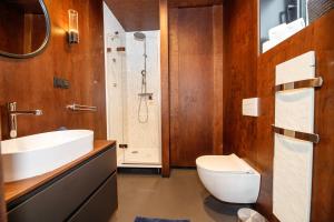 a bathroom with a toilet and a sink and a shower at Modul Kometa in Hrdoňov