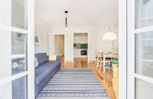 a living room with a couch and a table at Santos Green Apartment in Lisbon