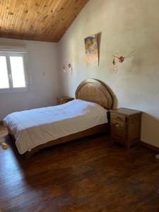 a bedroom with a large bed and a window at casa SamaSama in Porto-Vecchio