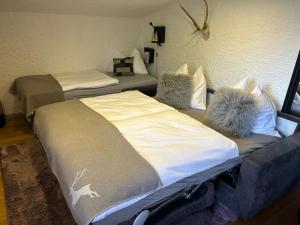 a room with two beds with pillows on them at Andys Bergjuwel in Leutasch