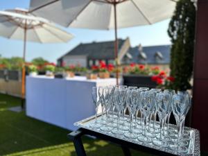 a group of wine glasses on a table with umbrellas at Best Western Plus Thionville Centre in Thionville