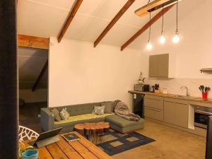 a living room with a couch and a kitchen at VILLA HOMITI in Hanga Roa