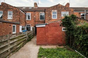 an old brick house with a gate and a fence at Stylish Home with Garden, Free Street Parking in Hull