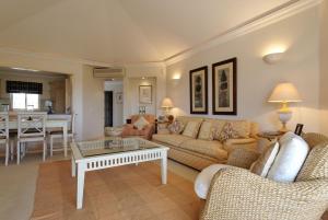un soggiorno con divano e tavolo di Tulio 2 Bedroom Luxury Apartment located in Encosta Do Lago a Quinta do Lago