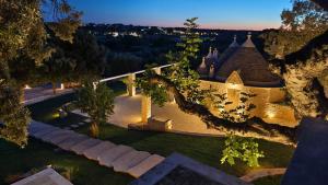 an aerial view of a house with a yard at Borgo Petra - with heated pool in Cisternino