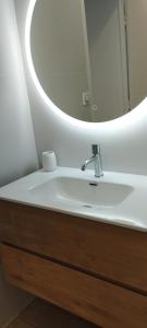 a bathroom with a sink and a mirror at Studio moderne, place parking privé, emplacement idéal à 100 m du lac. in Annecy
