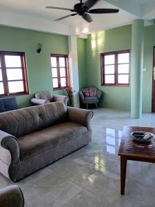 a living room with a couch and a table at Desired View in Choiseul