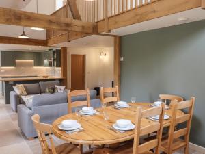 a dining room with a wooden table and chairs at Swallows Lodge in Edenbridge