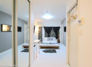 a hallway with a bedroom with a bed and a mirror at NEW! Shibuya Square Prime Unit, Heart of Tokyo! in Tokyo