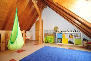 a childs room with a hammock in a attic at Casa Cara in Baiersbronn