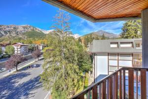 an apartment balcony with a view of a street and mountains at Il Rododendro City Center - Happy Rentals in Bardonecchia